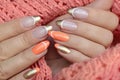 Colorful nail design with peach and golden nail polish