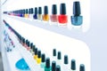 Colorful nail polish colors in a row at nails saloon on white Royalty Free Stock Photo