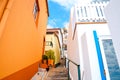 Colorful narrow cobbled street in village Jardim do Mar, Madeira, Portugal. Stone steps along with local buildings. Orange and Royalty Free Stock Photo