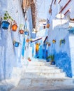 Colorful narrow old street in medina at sunny morning , Chefchaouen, Morocco Royalty Free Stock Photo