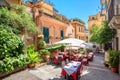 Street view with cafe in old town Taormina. Sicily, Italy Royalty Free Stock Photo