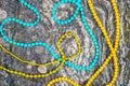 Colorful necklaces on mossy rock background Royalty Free Stock Photo