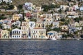 Colorful Neo-Classical Houses on Mountain Side of Symi Greece Facing the Mediterranean Sea Royalty Free Stock Photo