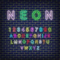 Colorful neon alphabets and numbers on neon brick wall