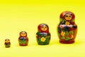 Colorful Nesting wooden Dolls isolated on bright yellow. National Russian souvenirs. Babushkas or Matryoshkas. Royalty Free Stock Photo