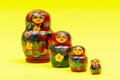 Colorful Nesting wooden Dolls isolated on bright yellow. National Russian souvenirs. Babushkas or Matryoshkas. Royalty Free Stock Photo