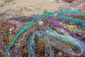 Colorful nets on beach. Trash in nature. Ecology crisis concept