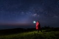 Colorful night sky with stars and silhouette of a standing man on the stone. Blue milky way with man on the mountain. High Rocks. Royalty Free Stock Photo