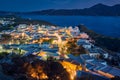 Colorful night view of traditional Greek small town or village by seafront, Plaka, Milos island, Cyclades, Greece. Royalty Free Stock Photo