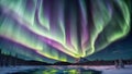 Colorful northern lights in green and purple colors over beautiful snowy forest, mountains and lake. The light is