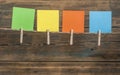 colorful note paper hanging on a rope over a wooden background Royalty Free Stock Photo