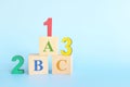 Colorful 123 numbers and abc letters alphabet on wooden blocks in blue background with copy space. Start of child or kid learning Royalty Free Stock Photo