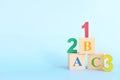 Colorful 123 numbers and abc letters alphabet on wooden blocks in blue background with copy space. Start of child or kid learning Royalty Free Stock Photo