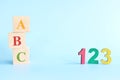 Colorful 123 numbers and abc letters alphabet on wooden blocks in blue background with copy space. Start of child or kid learning Royalty Free Stock Photo