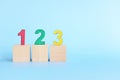 Colorful 123 numbers on wooden blocks in blue background with copy space. Start of child or kid learning counting concept. Royalty Free Stock Photo