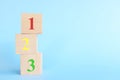 Colorful 123 numbers on wooden blocks in blue background with copy space. Start of child or kid learning counting concept. Royalty Free Stock Photo