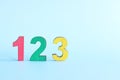 Colorful 123 numbers on wooden blocks in blue background with copy space. Start of child or kid learning counting concept. Royalty Free Stock Photo