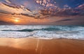 Colorful ocean beach sunrise with deep blue sky.
