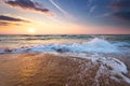 Colorful ocean beach sunrise with deep blue sky. Royalty Free Stock Photo