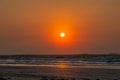 Colorful ocean beach sunrise with deep blue sky and sun rays. Royalty Free Stock Photo