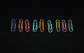 Colorful Office Pins on black background Royalty Free Stock Photo