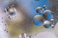 Colorful oil bubbles on a water surface abstract background with blue and yellow Royalty Free Stock Photo