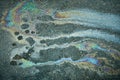 Colorful Oil Slick Creates Mesmerizing Patterns on Asphalt in Urban Environment Royalty Free Stock Photo