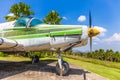 Colorful old airplane at park with gree tree and blue sky