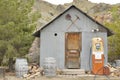 Old gas pump in desert next to tin shed