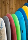 Colorful old hire surf boards against wooden wall Royalty Free Stock Photo