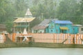 Colorful old houses and temple in the rain shower . Royalty Free Stock Photo