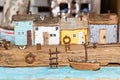 Colorful old miniature wooden houses stand on the embankment of the sea or river. Fishing nets. The boat is moored to the shore. Royalty Free Stock Photo