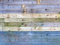 Colorful old rustic wooden plank wall or floor with some of the boards stained blue made of reused timber Royalty Free Stock Photo