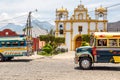 Colorful old school buses used as public transport in Guatemala at a church in Antigua