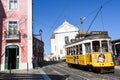 Colorful old tram acrossing colors building