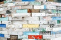 Colorful old wooden brick wall with peeling paint. Each one has two nail holes