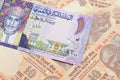 A colorful Omani riyal bank note on one dollar bills Royalty Free Stock Photo