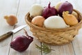 Colorful onions in a basket with a knife Royalty Free Stock Photo