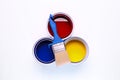 colorful open paint can red blue and yellow brush on it isolated on white background Royalty Free Stock Photo