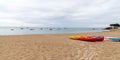 Colorful orange kayaks on ÃÅ½le de Noirmoutier sandy beach ready for paddlers in sunny day in web banner header template