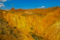 Red pinnacles of sandstone rocks at rainbow mountain canyon