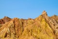 Red pinnacles of sandstone rocks at rainbow mountain canyon