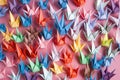 colorful origami crane collection on pastel background