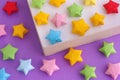 Colorful origami lucky stars in a paper box Royalty Free Stock Photo