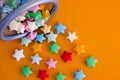 Colorful origami lucky stars spilling out of a bin Royalty Free Stock Photo