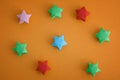 Colorful origami lucky stars on yellow background Royalty Free Stock Photo