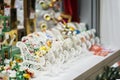 Colorful ornaments, Christmas balls and white wooden sledges. Sale of Christmas decorations. Abstract light blurred