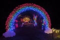 Colorful outdoor Christmas Holiday Light display with a rainbow tunnel and colorful lights Royalty Free Stock Photo