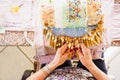 Colorful overhead shot of female hands making bobbin lace Royalty Free Stock Photo