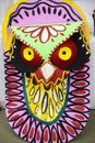 Colorful owl mask hanging on Art institute wall.